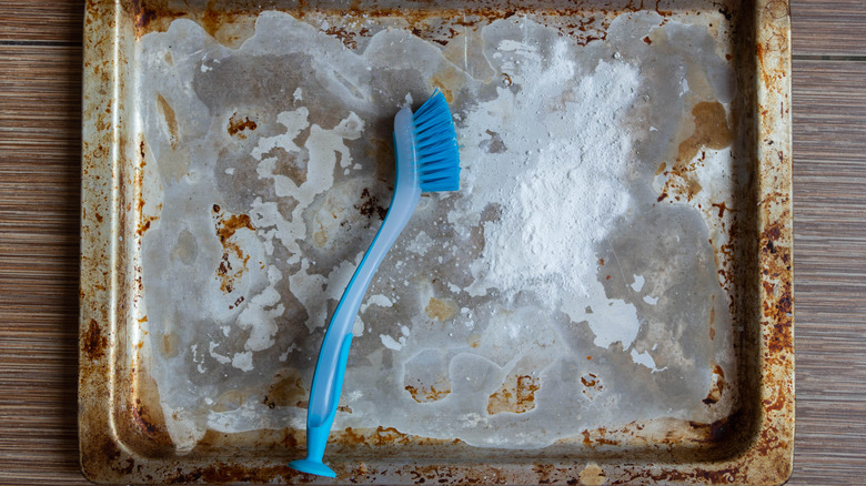 baking soda on aluminum tray with brush