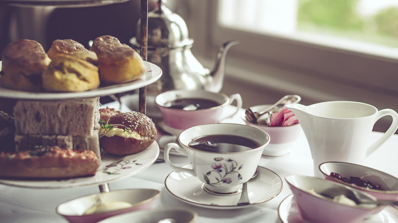 A lovely pink and white afternoon tea set and spread awaits patrons