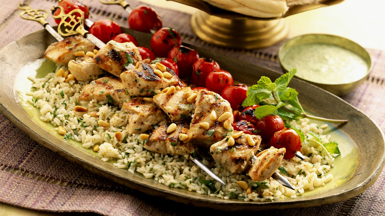 plate of kebabs, tomatoes, and rice