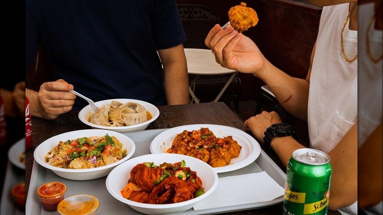 People eating Nepalese dishes