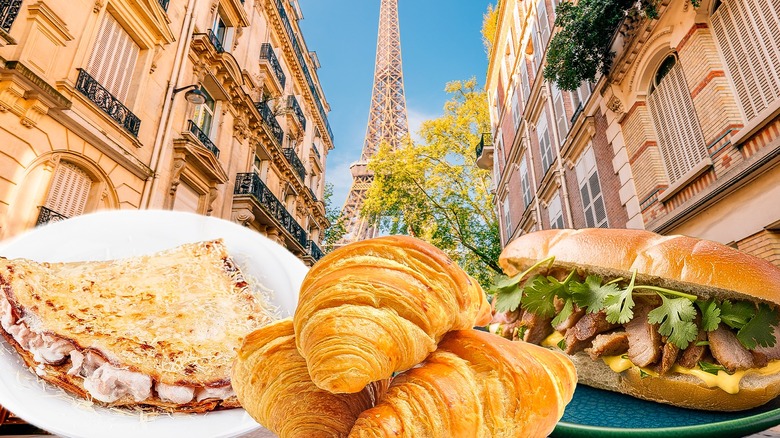 Parisian buildings and Eiffel Tower with a savory crepe, croissants, and banh mi in foreground