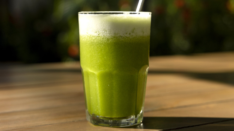 green smoothie on plain backdrop