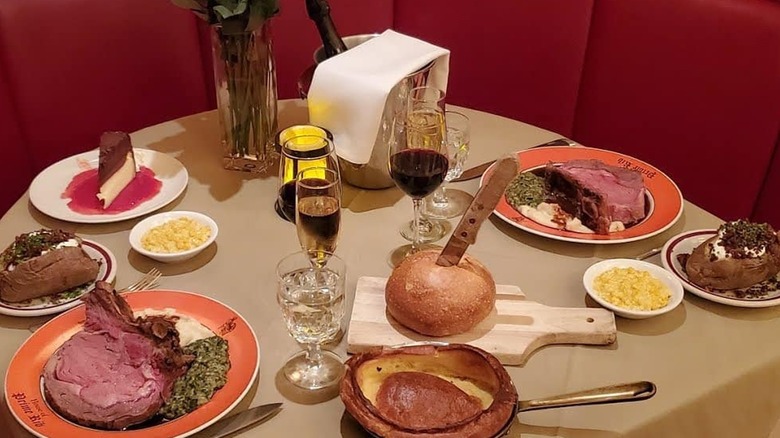 A table at the House of Prime Rib, featuring cuts of beef, sides, and bread