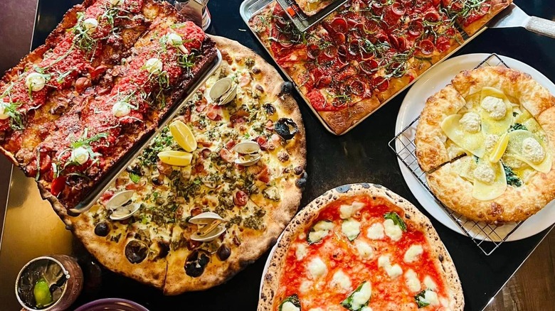 Table full of different pizzas, from Tony's in San Francisco