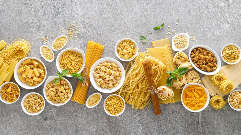 Bowls filled with different types of dried pasta