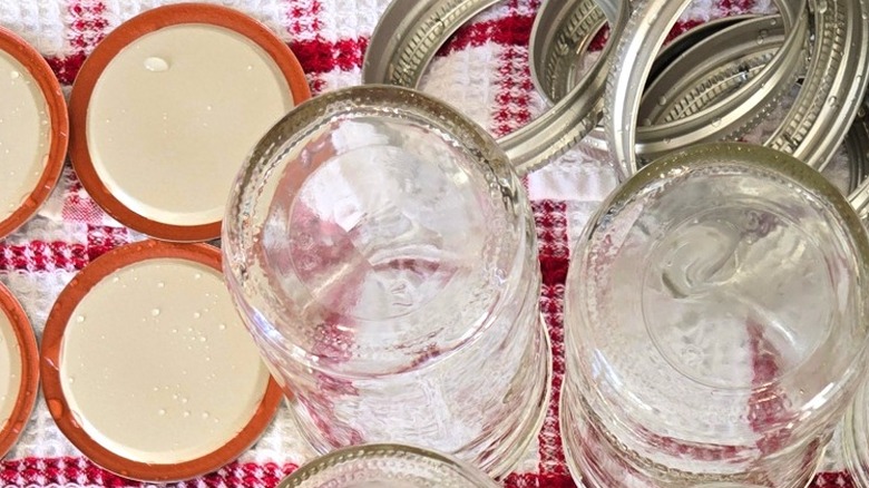 Mason jars and canning lids drying on towel