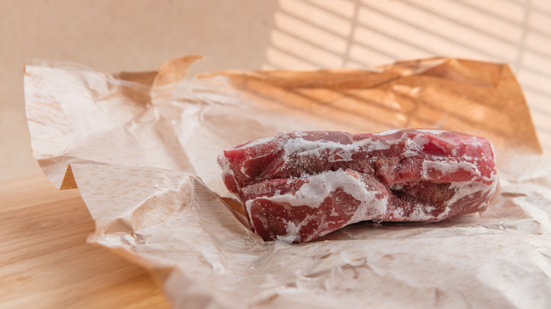 frozen steak on brown paper