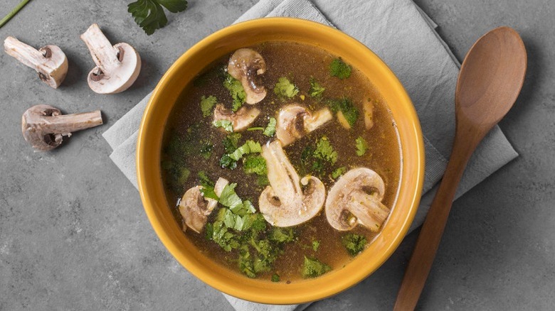 Brown broth mushroom soup with seasoning