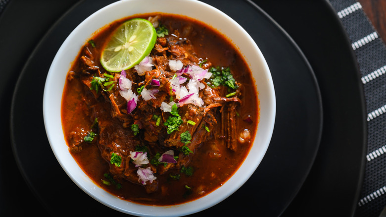 top down birria bowl with a slice of lime