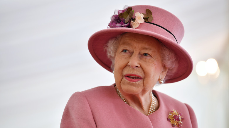 Queen Elizabeth in a pink hat and blazer