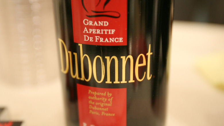 A bottle of Dubonnet Rouge sports a red label bearing the words "Grand Aperitif De France."