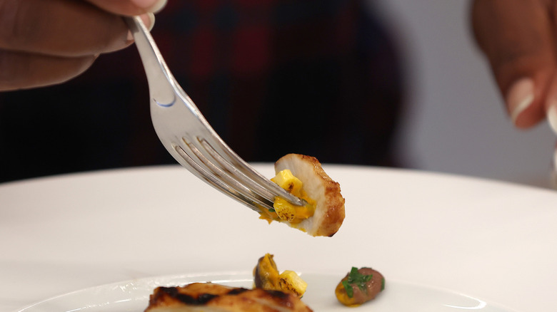 Diner tries a GOOD Meat cultivated chicken dish.