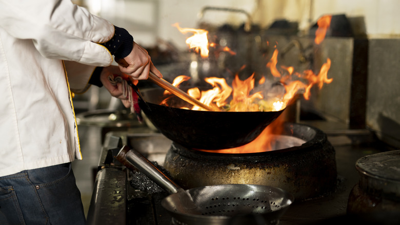 Chef with flaming wok