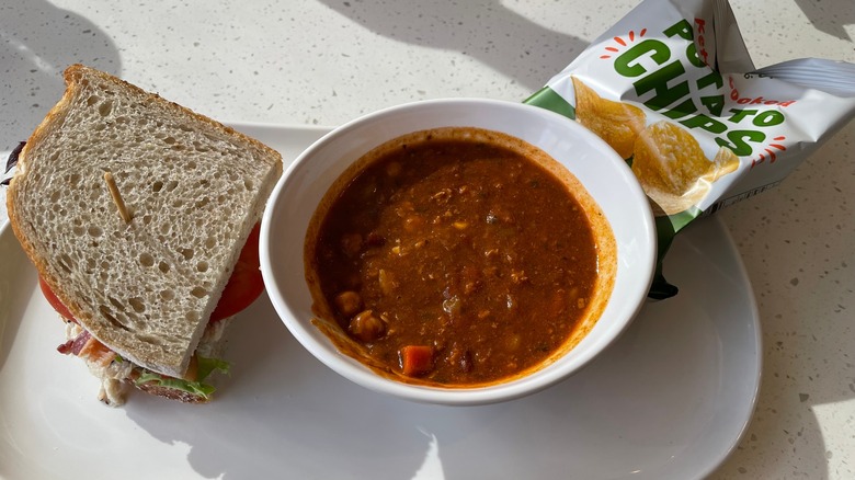 Panera Bread soup with a half sandwich and chips