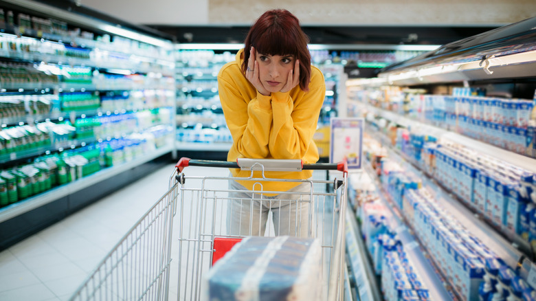 Stressed woman at grocery store