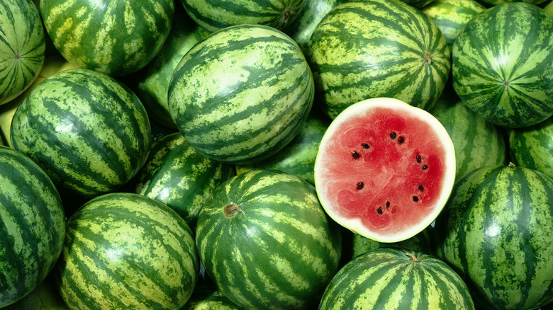 Half watermelon on watermelon pile