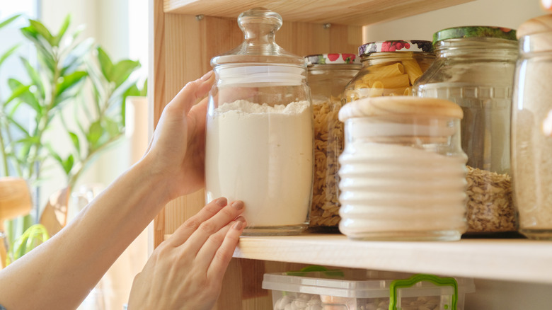 Person reaching for flour jar