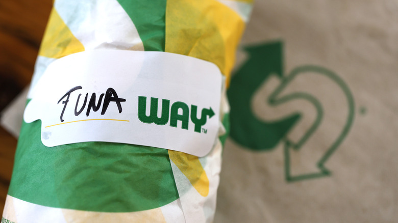 a subway sandwich marked tuna in a wrapper