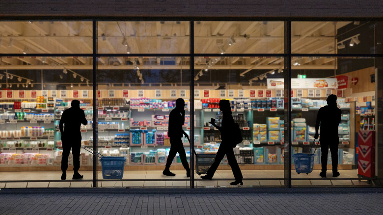 People grocery shopping at night