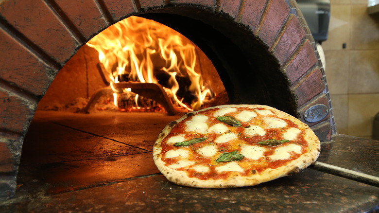 Margherita pizza and pizza oven