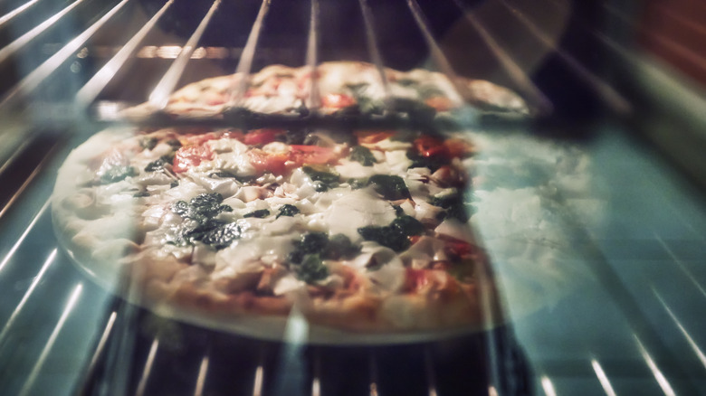 Pizza cooking in oven