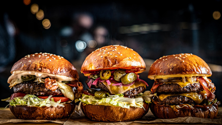 Three burgers with different toppings