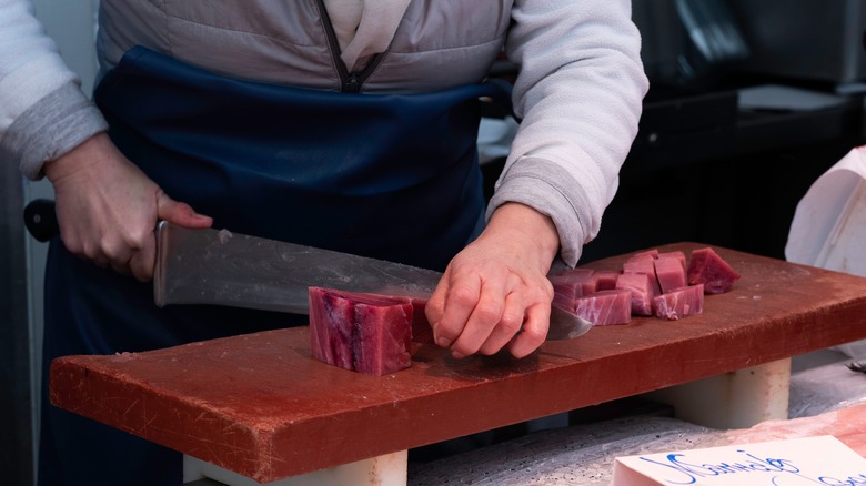 Fishmonger cutting tuna