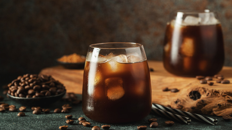 iced coffee pictured alongside beans