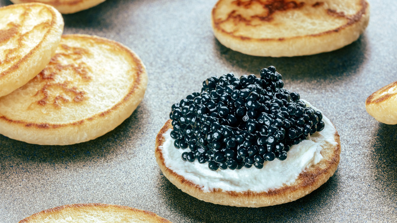 Closeup of black caviar served over blini