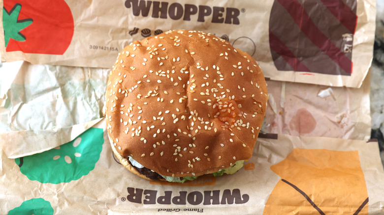 A Whopper on a paper Burger King wrapper