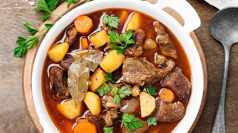 beef stew with vegetables on a wooden table