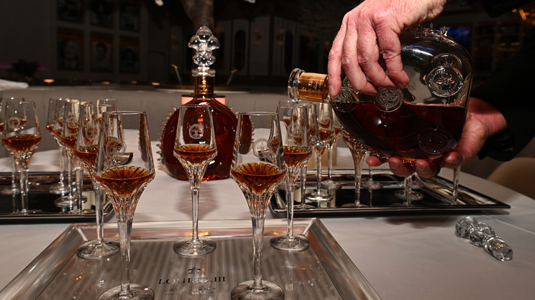 Cognac being poured into elegant cut crystal glasses