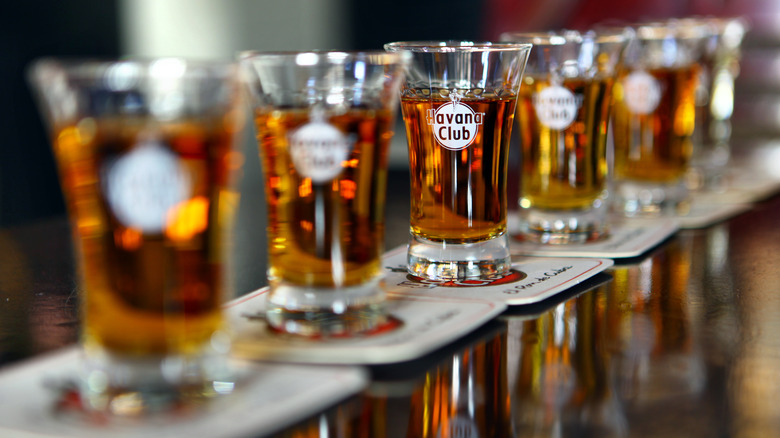 Shots of Havana Club rum lined up on coasters