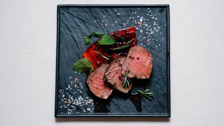 Sliced chateaubriand is simply plated in three slices.