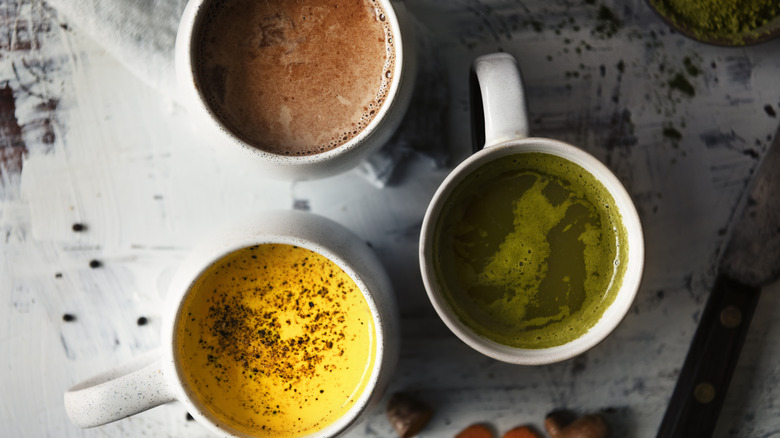 Three white mugs of naturally caffeinated drinks