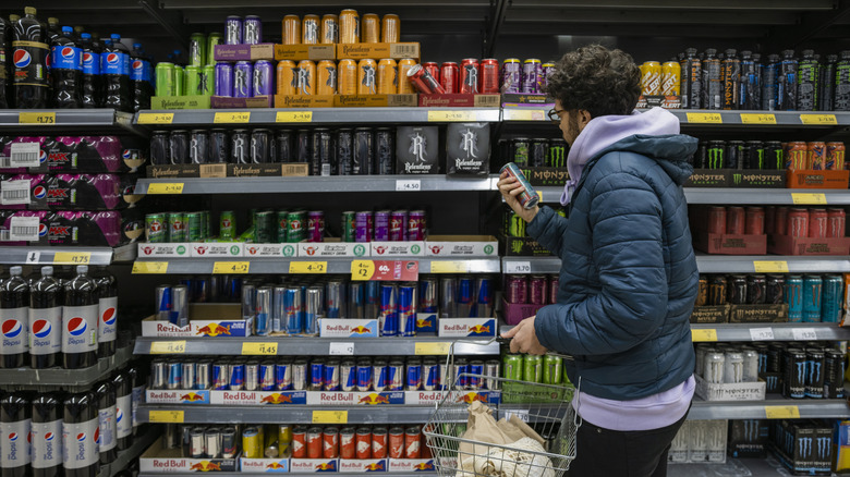 Person shopping for energy drinks in the grocery store