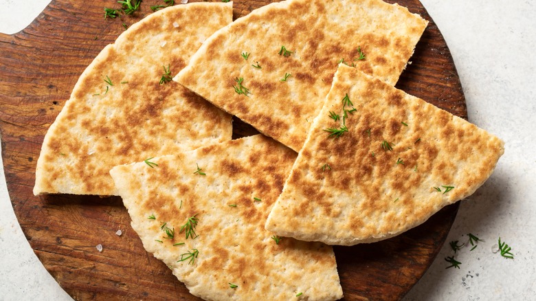 pita slices on a wooden board