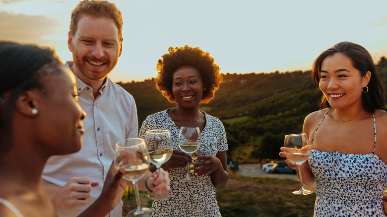 group of friends enjoying white wine outside