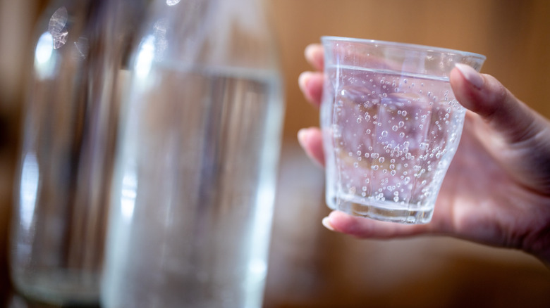 sparkling water held in hand