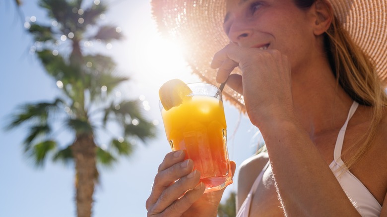 woman holding cocktail