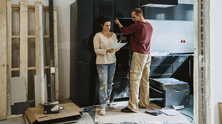 Couple renovating a kitchen