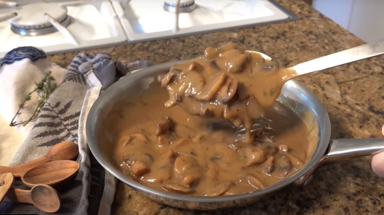 Brown mushroom gravy in pan