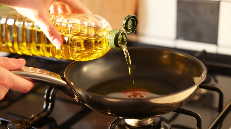 Pouring vegetable oil into pan