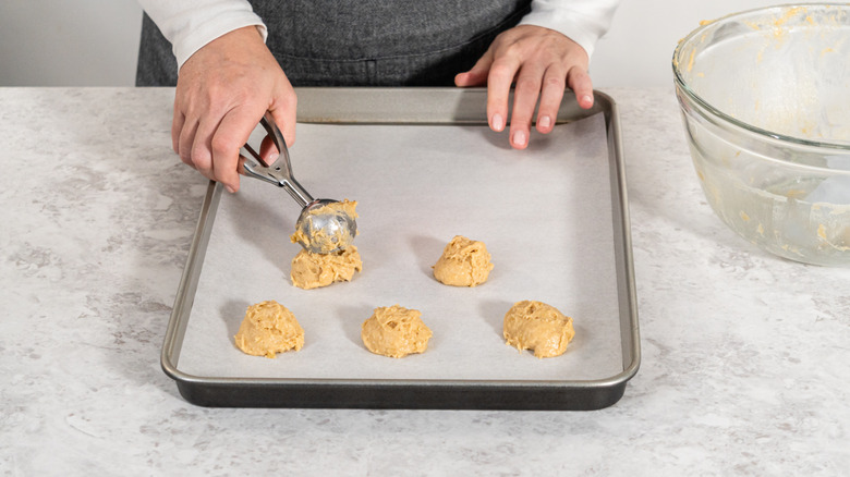 Dropping cookie dough on parchment