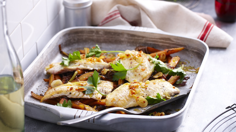 Baked or broiled fish sitting in a pan