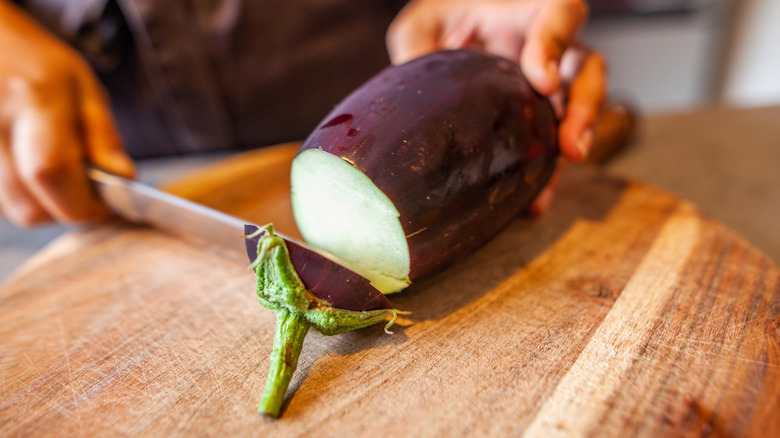 Eggplant being prepared and cut