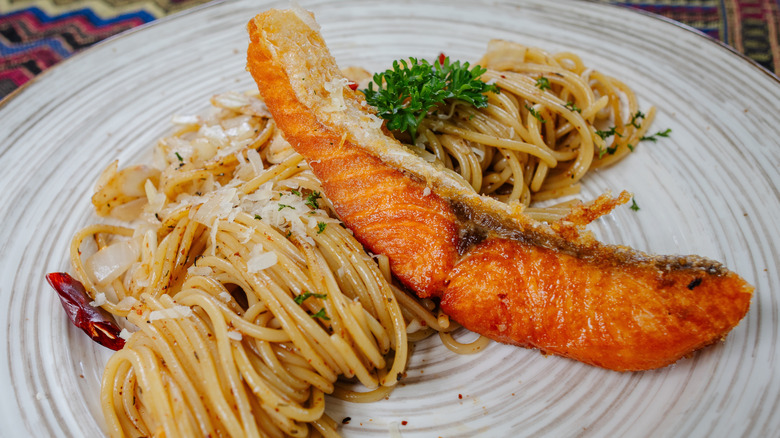 Plate of spaghetti with fried salmon