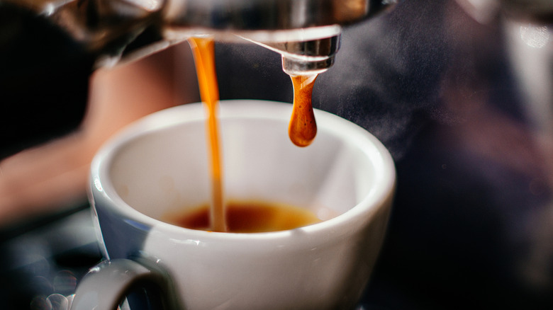 An espresso machine pouring espresso into a cup