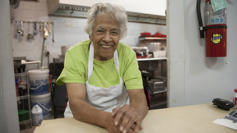 Chef Leah Chase smiling in the kitchen at Dooky Chase Restaurant