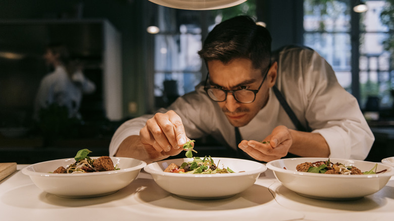 chef plating vegetarian dishes